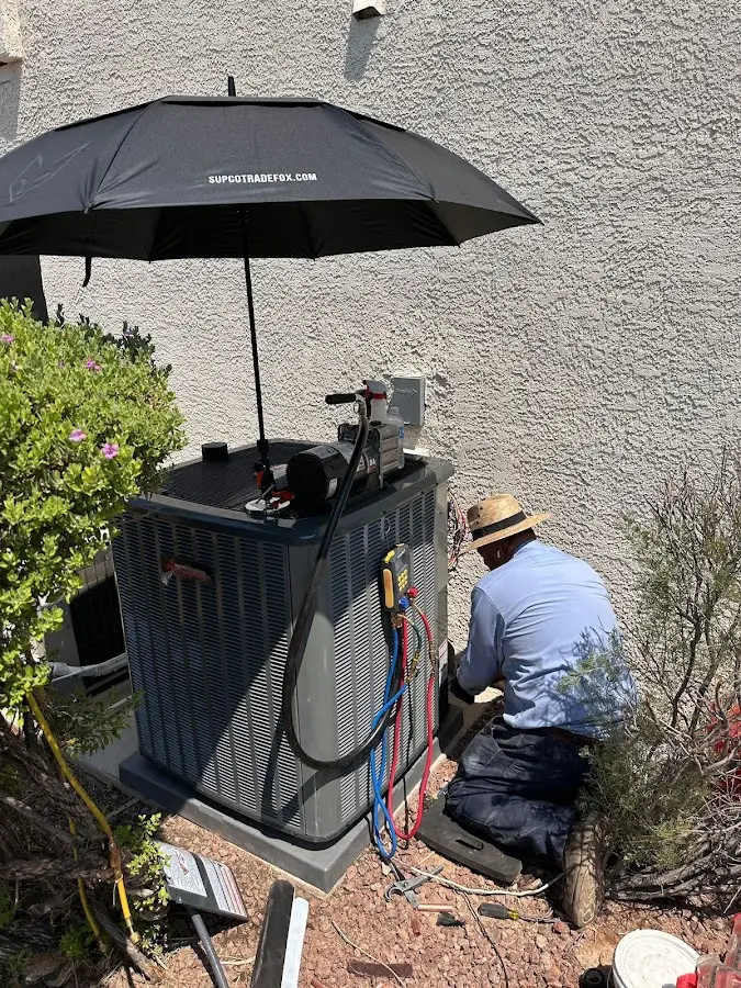 HVAC technician performing outdoor AC maintenance in Dearborn Heights